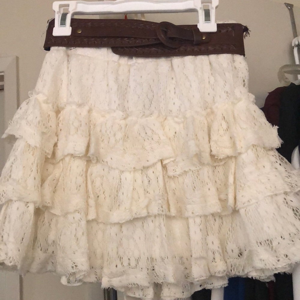 white ruffled skirt with brown belt